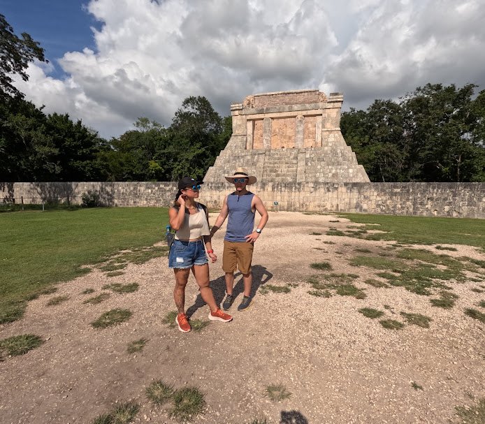 Tourists enjoying a guided tour of a historical site in Yucatan.