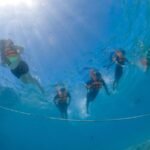 Group of snorkelers exploring vibrant coral reefs during a snorkeling tour.